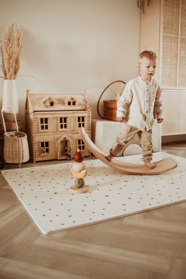 PlayandGo_EEVAA_treehouse_puzzlemat_child_standing_on_a_swing_board_on_the_EEVAA_mat_in_a_kids_room Play&Go 3u1 EEVAA dvostrana podloga za igru – Kućica na drvetu/Zvjezdice (120x180cm) - Image 5